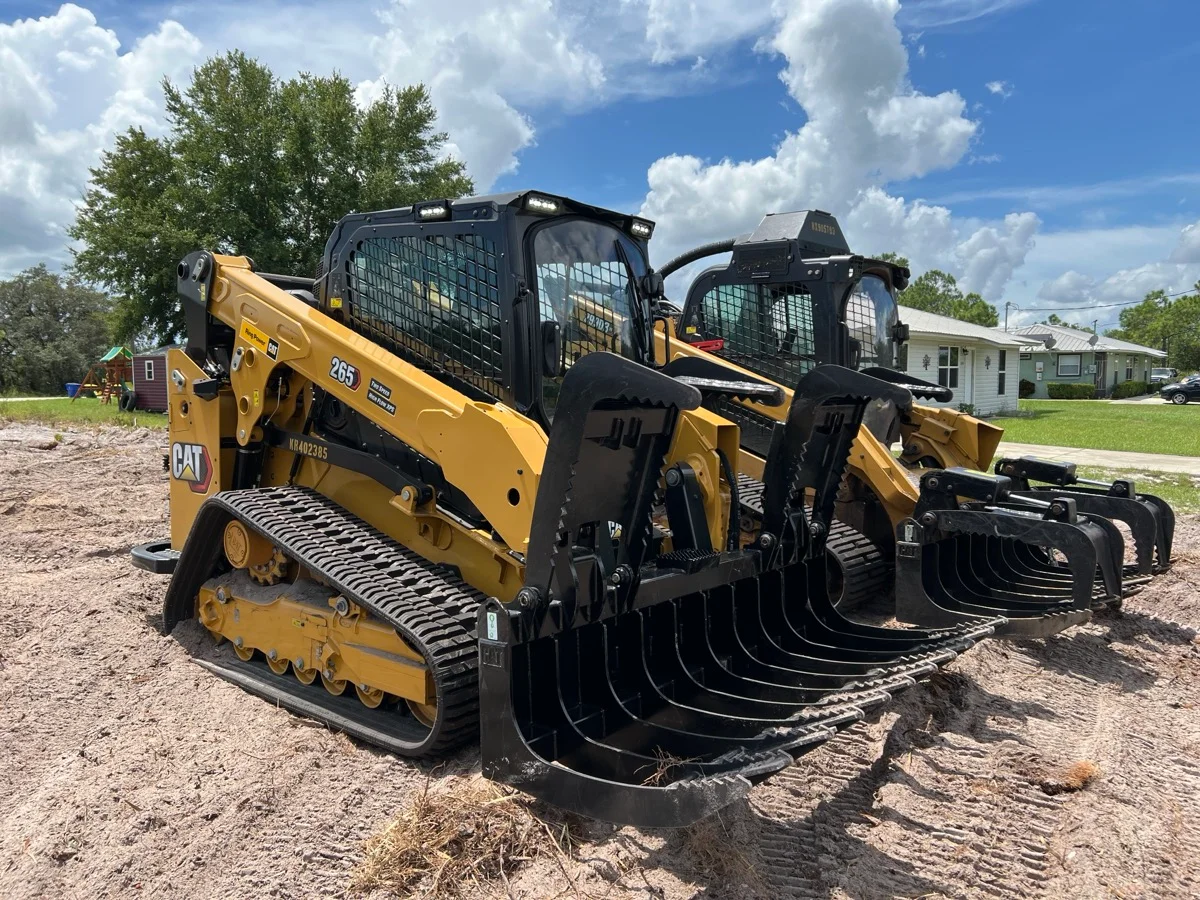CAT excavator clearing land for construction site preparation